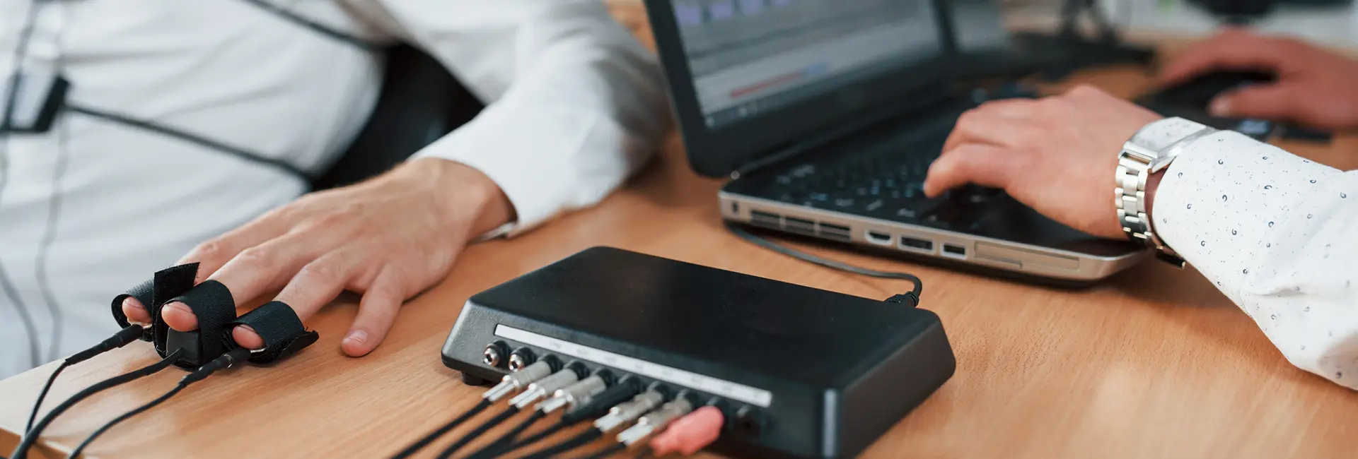polygraph test being administered and results being recorded on a computer